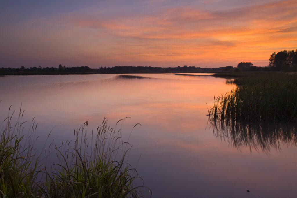 England, Tyne and Wear, Big Waters County Park. Sunset over the lake in Big Waters Country Park The lake is a a subsidence pond, formed by the collapse of old mine workings.