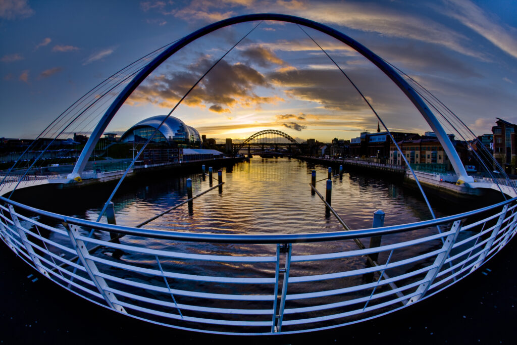 The Gateshead Millennium Bridge, Sage, Tyne Bridge and Newcastle upon Tyne river quayside.