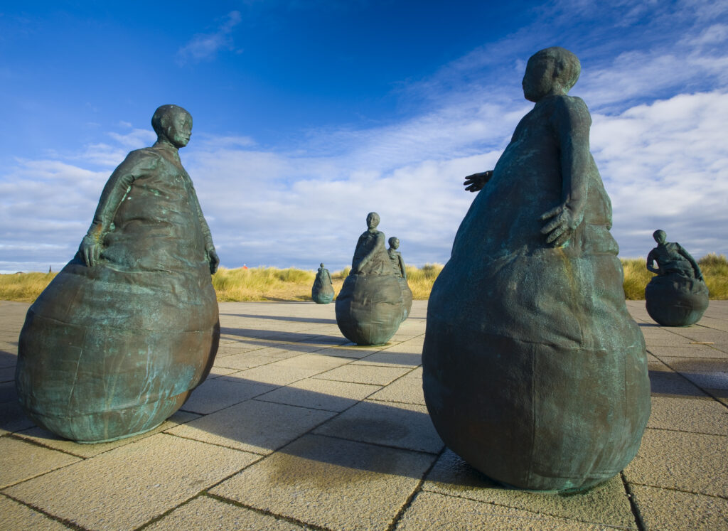 England, Tyne & Wear, South Shields. Bronze statues forming the "Conversation Piece" artwork located near Little haven Beach.
