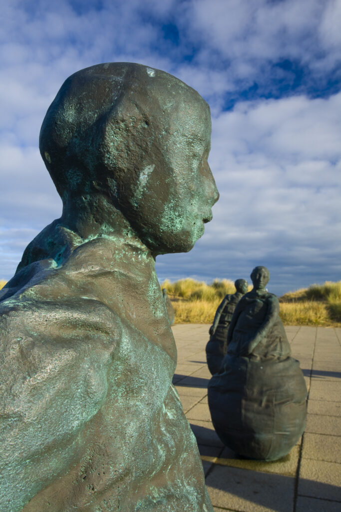 England, Tyne & Wear, South Shields. Bronze statues forming the "Conversation Piece" artwork located near Little haven Beach.