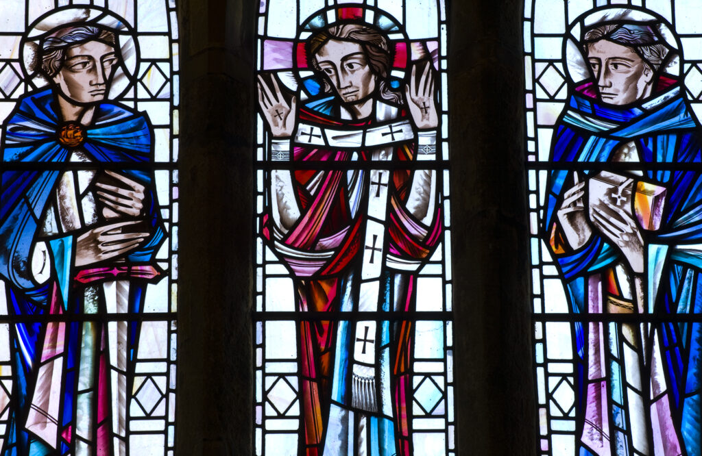 East wall stained glass window in the Chancel depicting St Paul, Risen Christ and the Venerable Bede.