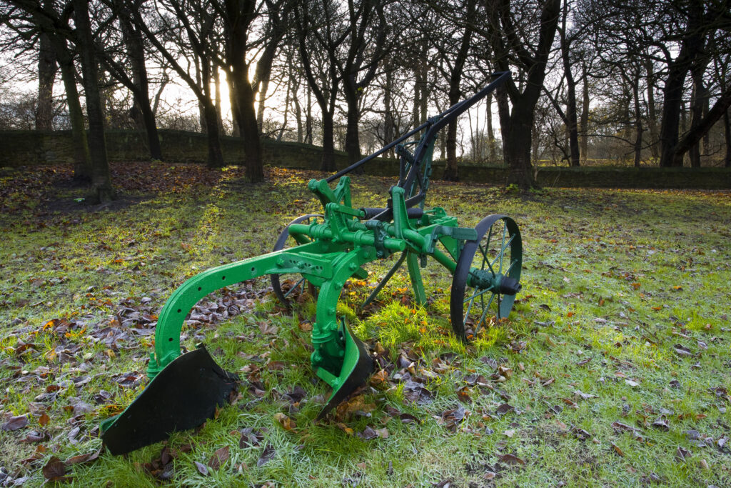 England, Tyne & Wear, Backworth. Hand plough in Backworth Village, depicting the farming heritage of the Tyneside region.
