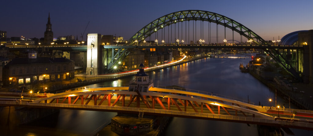 England, Tyne & Wear, Newcastle Upon Tyne. Panoramic view of the River Tyne and Tyne Bridge with the Swing Bridge in the foreground.