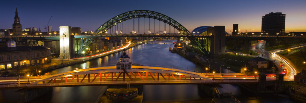 England, Tyne & Wear, Newcastle Upon Tyne. Panoramic view of the River Tyne and Tyne Bridge with the Swing Bridge in the foreground.