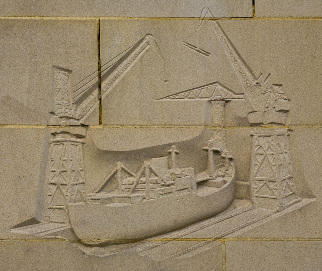 England, Tyne and Wear, Newcastle Upon Tyne. Carving on the reconstructed city wall near the quayside heralding the ship building heydays of Newcastle Upon Tyne.