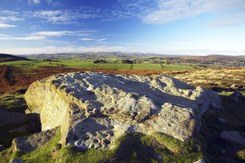 England, Northumberland, Northumberland National Park. Pre-historic cup and ring marks / rock art on a stone at Lordenshaw near the Lordenshaw Hill Fort