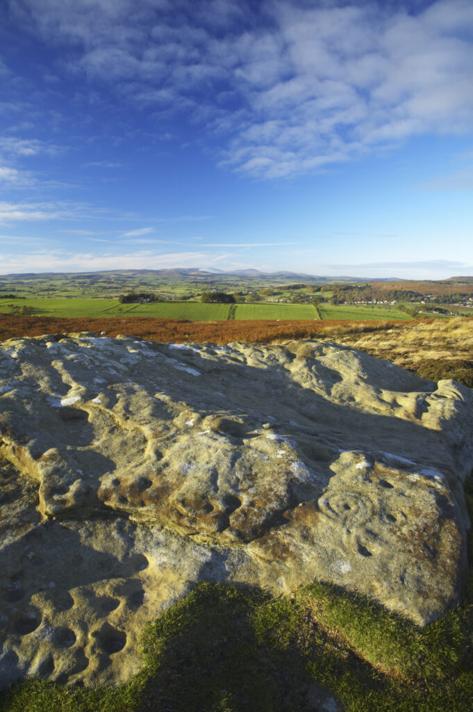 England, Northumberland, Northumberland National Park. Pre-historic cup and ring marks / rock art on a stone at Lordenshaw near the Lordenshaw Hill Fort
