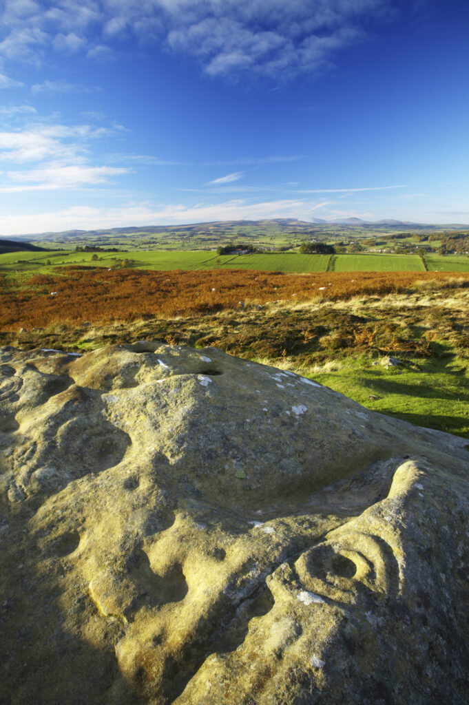 England, Northumberland, Northumberland National Park. Pre-historic cup and ring marks / rock art on a stone at Lordenshaw near the Lordenshaw Hill Fort