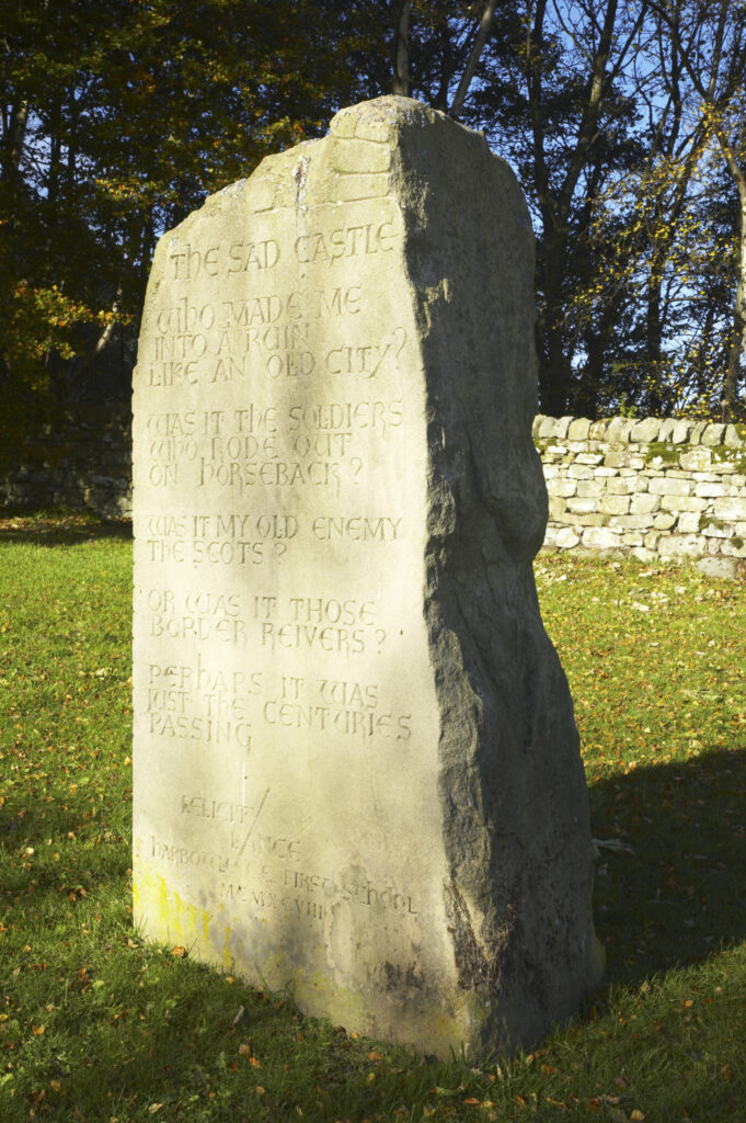 England, Northumberland, Northumberland National Park. Stone monument and autumn colours near the remains of Harbottle Castle in Coquetdale