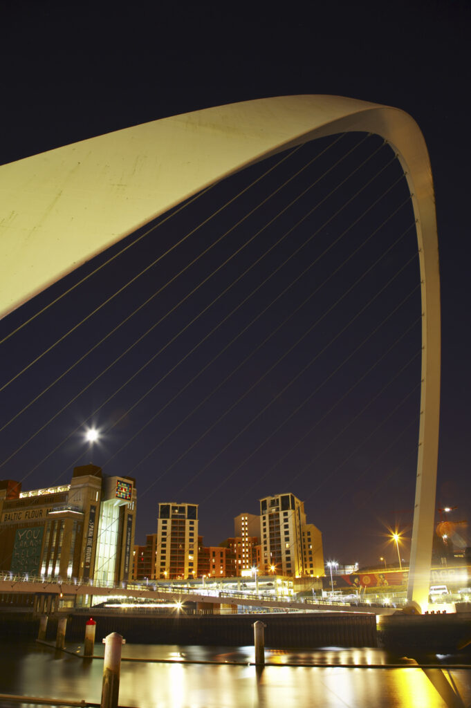 The Millennium Bridge and the River Tyne, viewed at night from the Newcastle upon Tyne Quayside