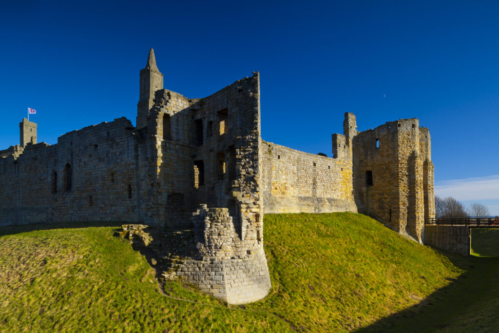 England, Northumberland, Warkworth. Warkworth Castle is a 12th-century stone motte and bailey fortress located near the Northumberland Heritage Coast.