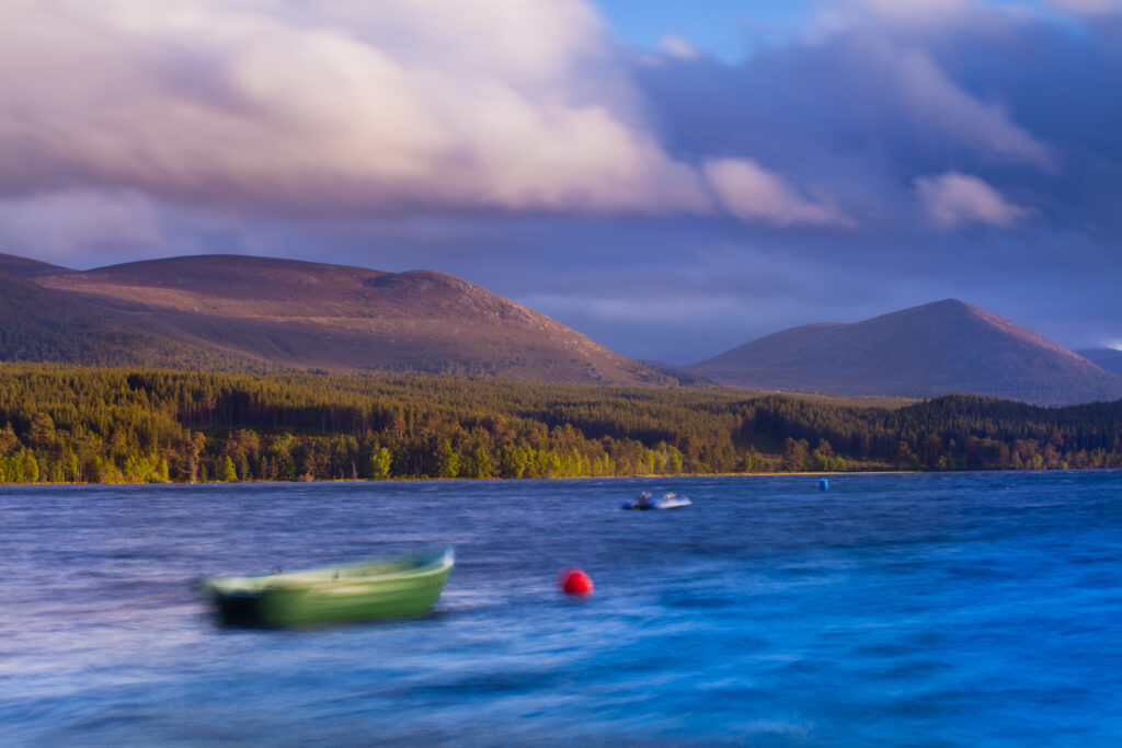 Scotland, Scottish Highlands, Cairngorms National Park. A stormy evening on Loch Morlich with the Cairngorm Moutain Range in the distance.