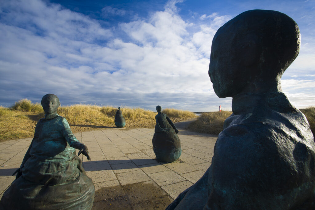 England, Tyne & Wear, South Shields. Bronze statues forming the "Conversation Piece" artwork located near Little haven Beach.