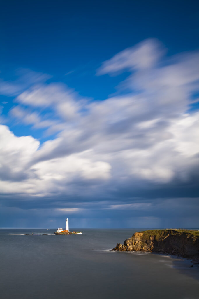 England, Tyne and Wear, St Mary's Island and Lighthouse. Rain clouds pass the enigmatic St Mary's Island and Lighthouse near Whitley Bay.