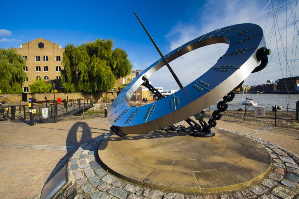 England, Greater London, London Borough of Tower Hamlets. Sun dial near the entrance to the St Katharine Docks, on the north bank of the River Thames near the London Tower Bridge.