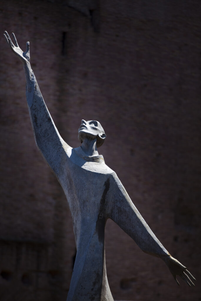 Italy, Lazio, Rome. Abstract view of a statue reaching towards the sky, located near the Colosseum in Rome City.