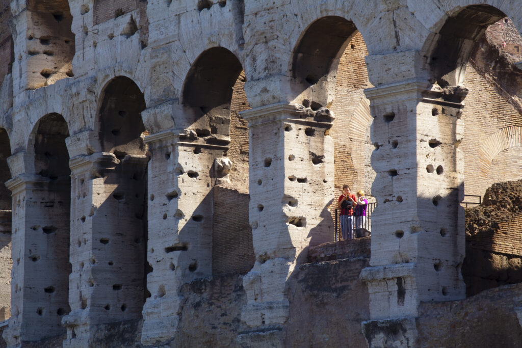 Italy, Lazio, Rome. Tourists in the Colosseum or Roman Coliseum, originally the Flavian Amphitheatre