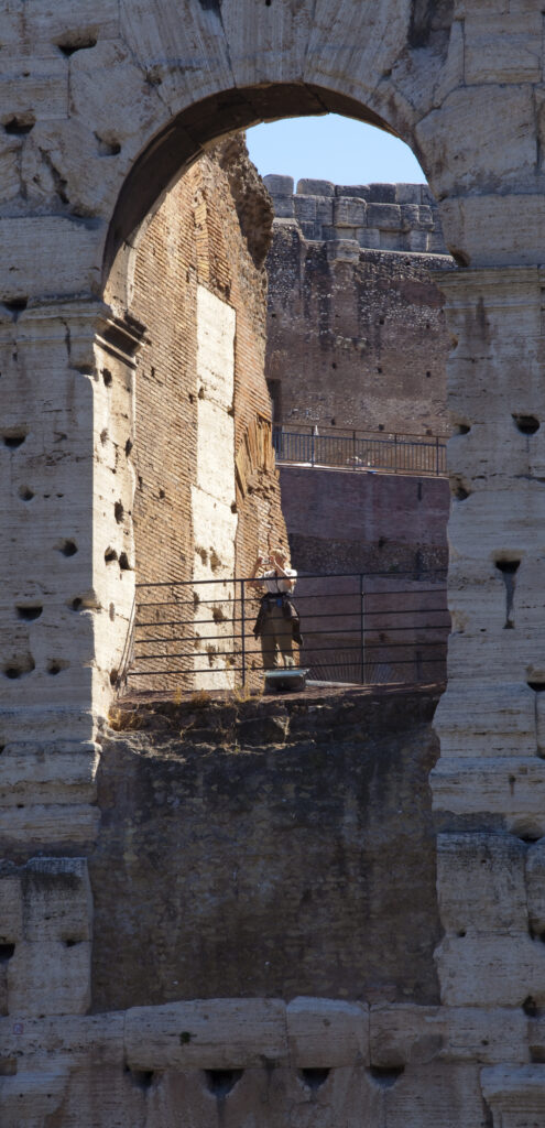 Italy, Lazio, Rome. Tourist in the Colosseum or Roman Coliseum, originally the Flavian Amphitheatre