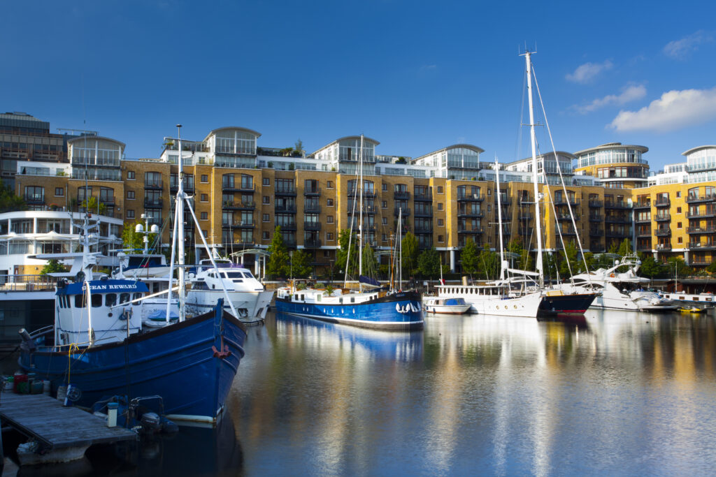 England, Greater London, London Borough of Tower Hamlets. Boats moored in the St Katharine Docks, a popular housing and leisure complex in the area known as the Docklands on the north bank of the River Thames near the London Tower Bridge.