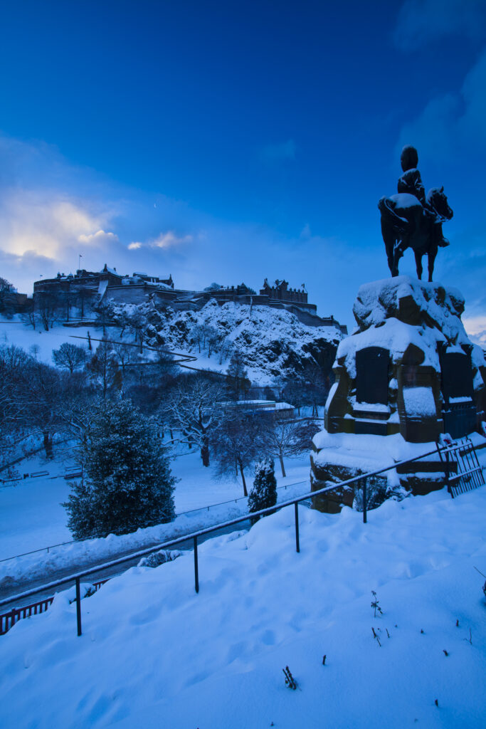 Scotland, Edinburgh, Edinburgh City. Edinburgh Castle and Princes Garden under a blanket of snow.