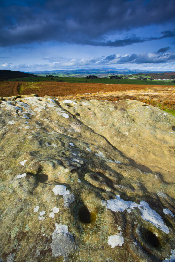 England, Northumberland, Northumberland National Park. Pre-historic cup and ring marks / rock art on a stone at Lordenshaw near the Lordenshaw Hill Fort