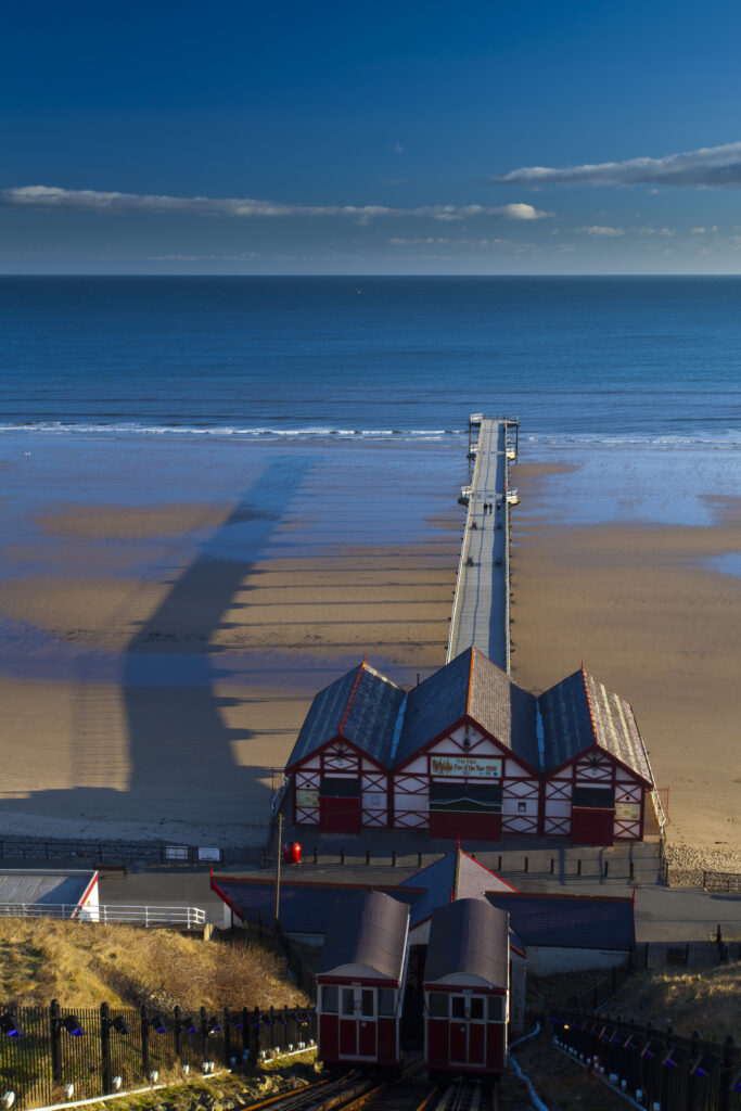 England, Cleveland, Saltburn-by-the-Sea. View from the top of the funicular railway, one of the world's oldest water-powered cliff lifts, towards the Victorian Pier and North Sea Beach.