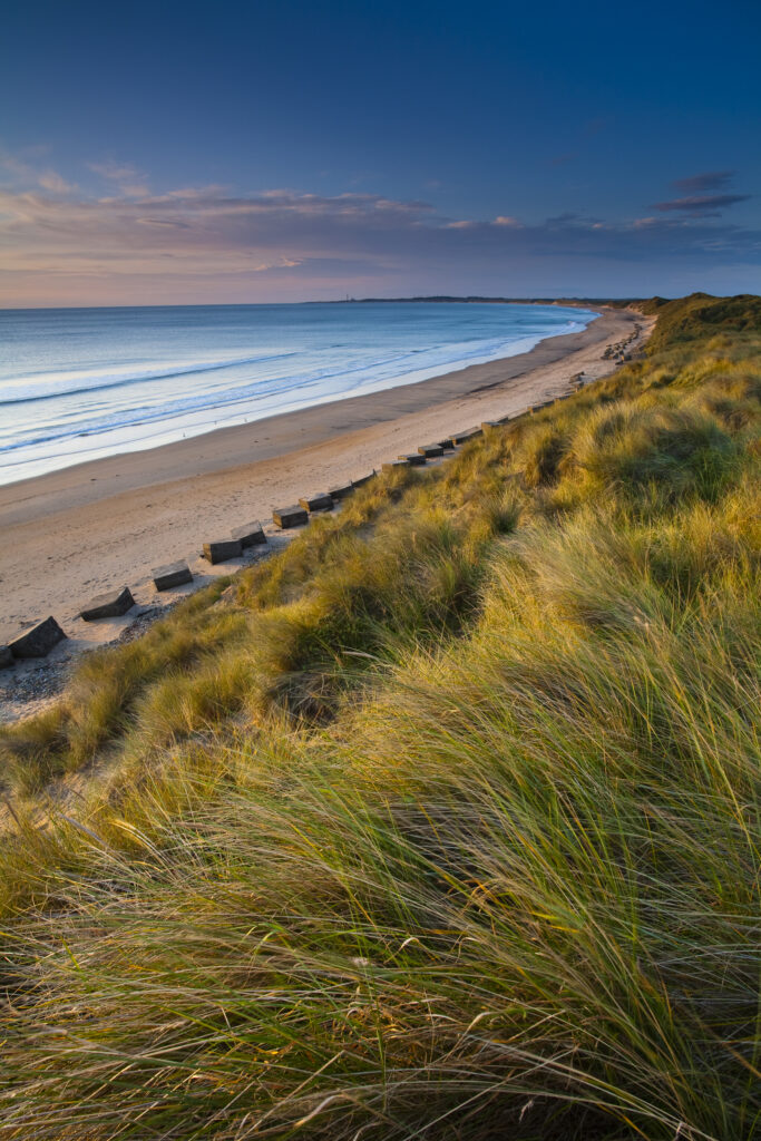 England, Northumberland, Druridge Bay. World War Two anti-tank blocks defending the picturesque beach at Druridge Bay.