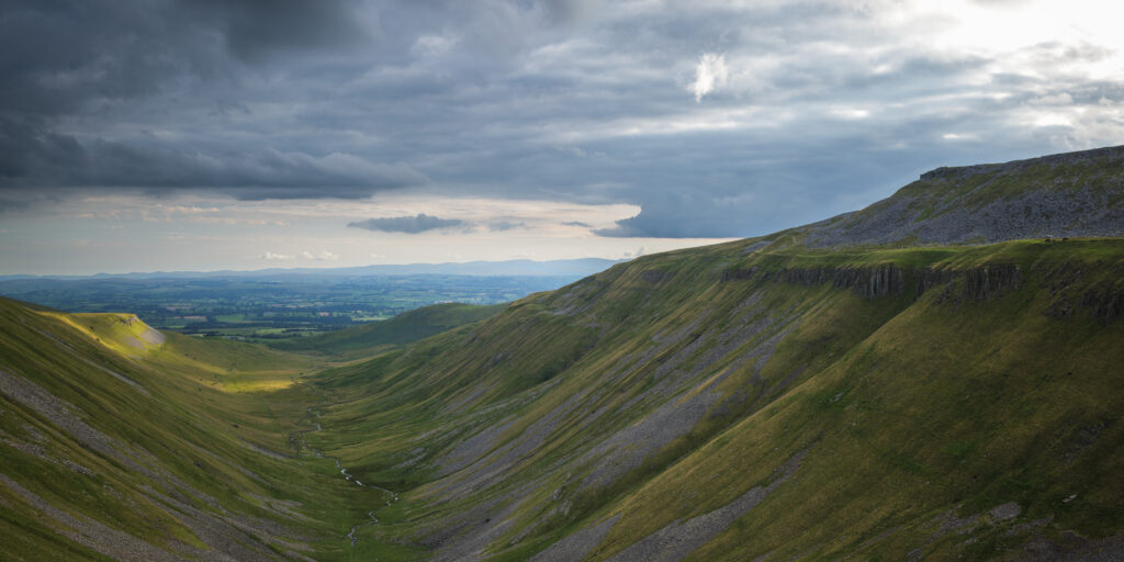 England, Cumbria, High Cup Nick. High Cup Gill — also known as High Cup Nick — is a strikingly symmetrical U-shaped valley carved deep into the Pennine escarpment near Appleby-in-Westmorland, Cumbria, within the North Pennines Area of Outstanding Natural Beauty.