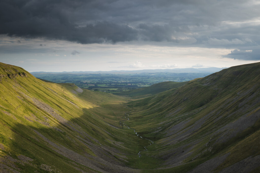 England, Cumbria, High Cup Nick. High Cup Gill — also known as High Cup Nick — is a strikingly symmetrical U-shaped valley carved deep into the Pennine escarpment near Appleby-in-Westmorland, Cumbria, within the North Pennines Area of Outstanding Natural Beauty.