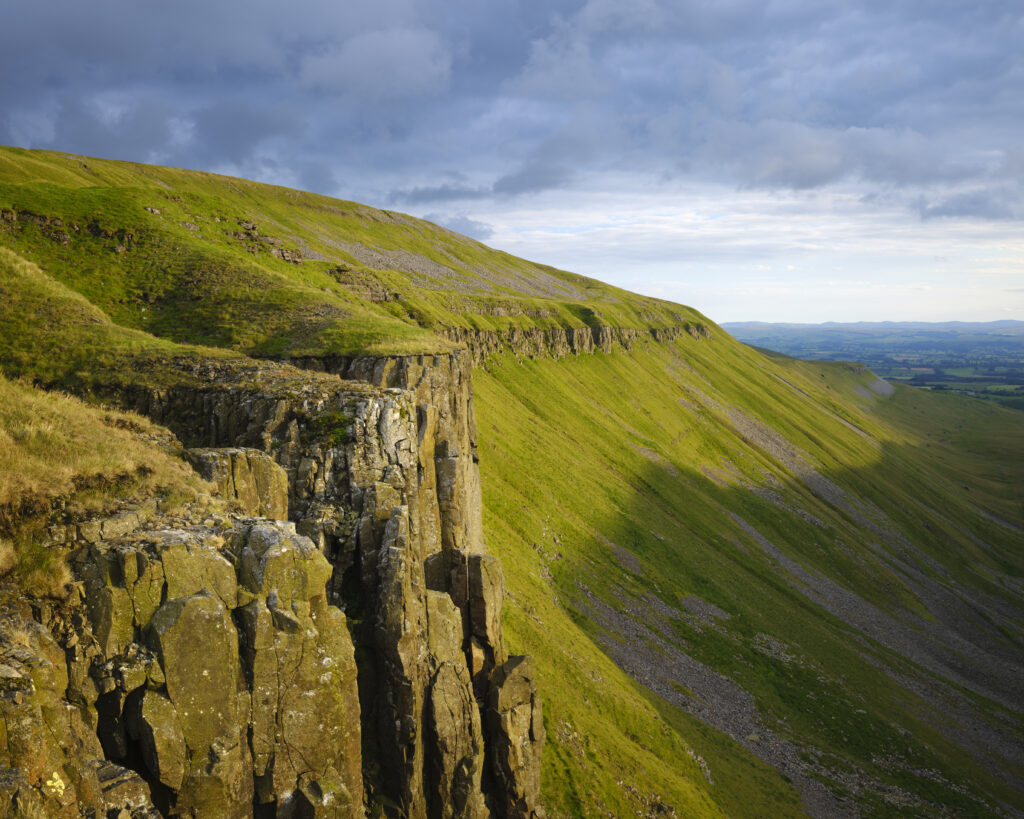 England, Cumbria, High Cup Nick. High Cup Gill — also known as High Cup Nick — is a strikingly symmetrical U-shaped valley carved deep into the Pennine escarpment near Appleby-in-Westmorland, Cumbria, within the North Pennines Area of Outstanding Natural Beauty.