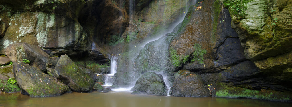 England, Northumberland, Routin Linn. Located near Ford in North Northumberland, Routin Linn is a picturesque waterfall situated in a vegetated ravine.