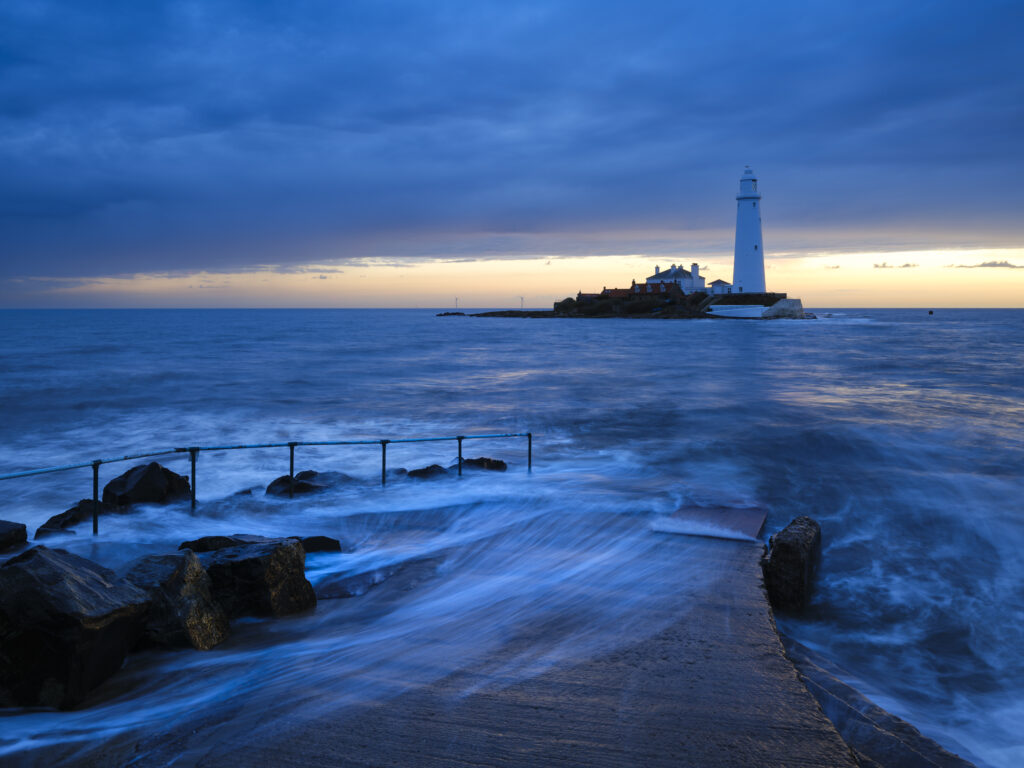 England, Tyne and Wear, St Mary's Island. Pre-dawn at high tide with the north sea covering the causeway to St Mary's Island and lighthouse, a popular location near Whitley Bay.