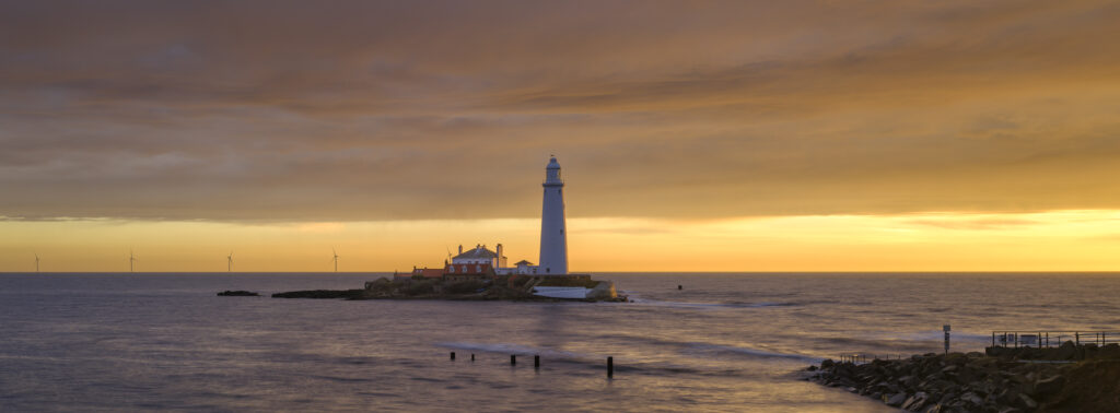 England, Tyne and Wear, St Mary's Island. Sunrise at high tide with the north sea covering the causeway to St Mary's Island and lighthouse, a popular location near Whitley Bay.