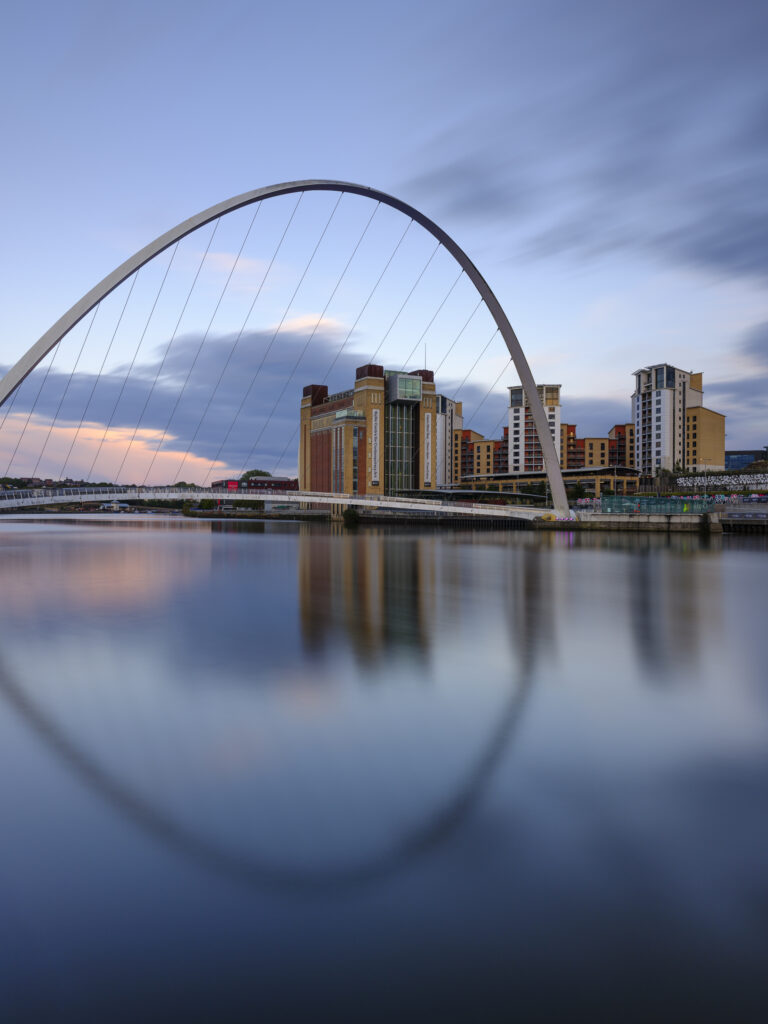 England, Tyne and Wear, Newcastle Upon Tyne. The Baltic Gallery in Gateshead, with the Millennium Bridge crossing the River Tyne.