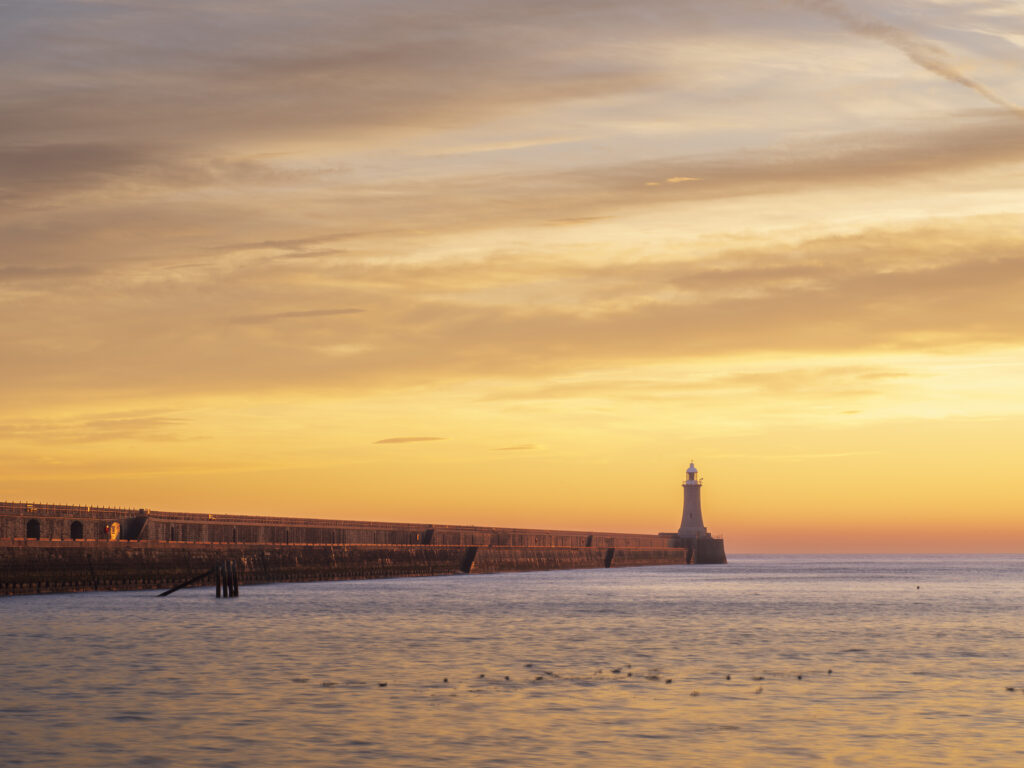 England, Tyne and Wear, Tynemouth. The north tyne pier lighthouse guides ships coming through the river Tyne from the north sea
