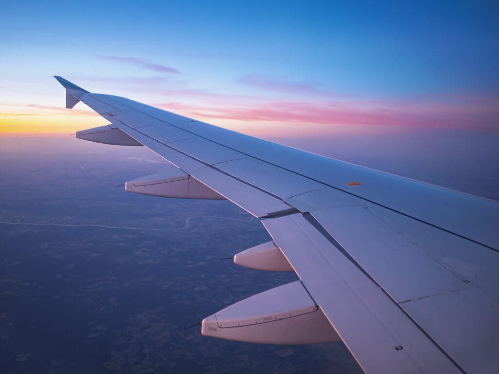 Airplane Wing Above Germany at Sunset.