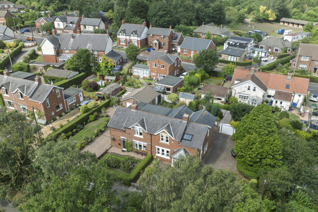 Drone property photography showing a house and surrounding neighbourhood