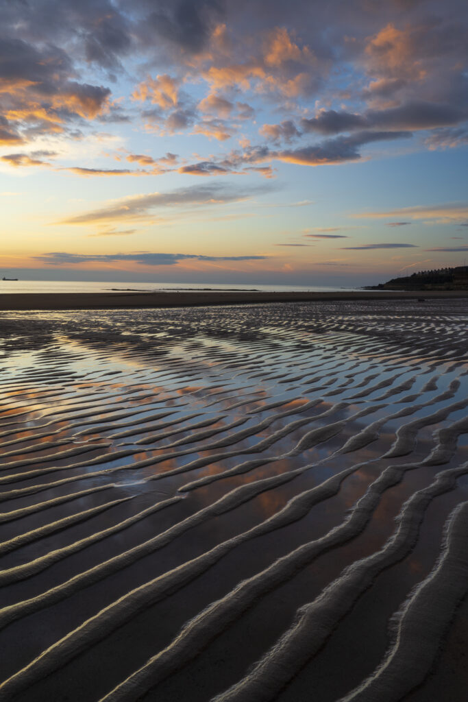 England, Tyne and Wear, Whitley Bay. Sand ripples on the beach at Whitley Bay near Watts Slope viewed at sunrise.