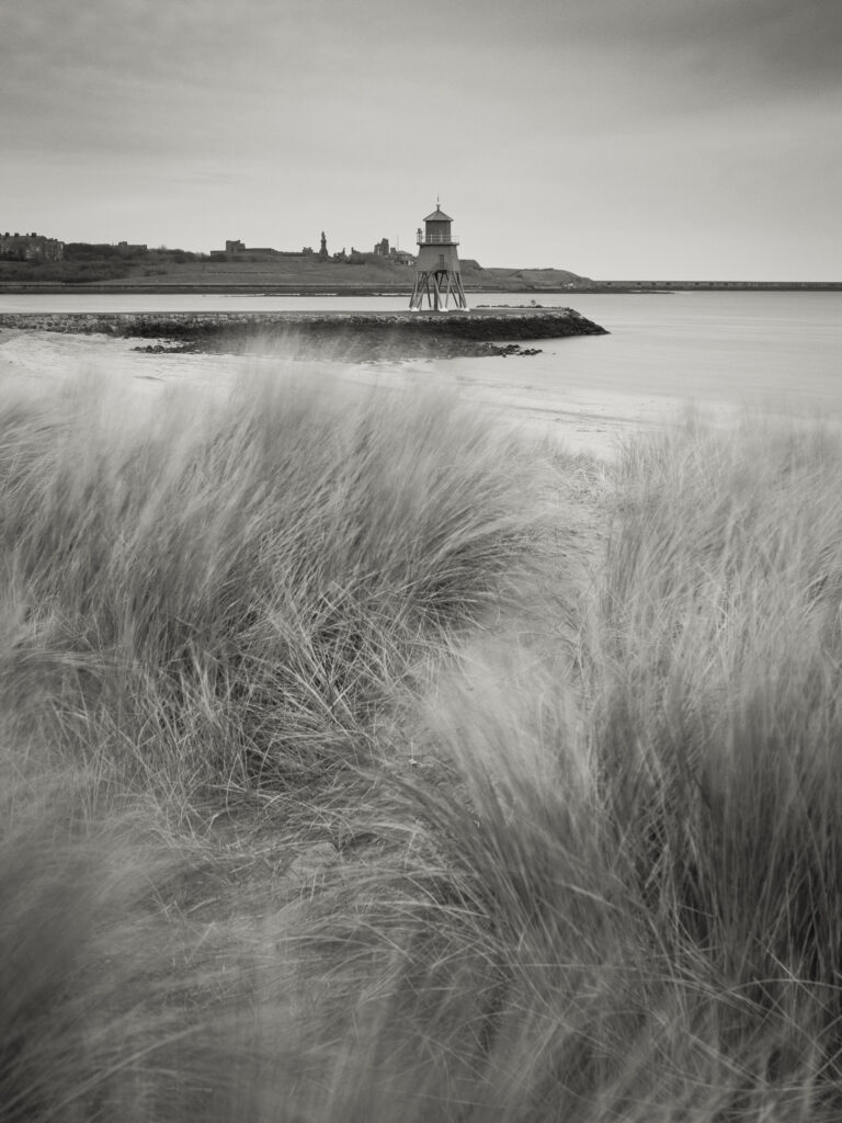 England, Tyne & Wear, South Shields. Little Haven Beach, looking towards the South Groyne Lighthouse.