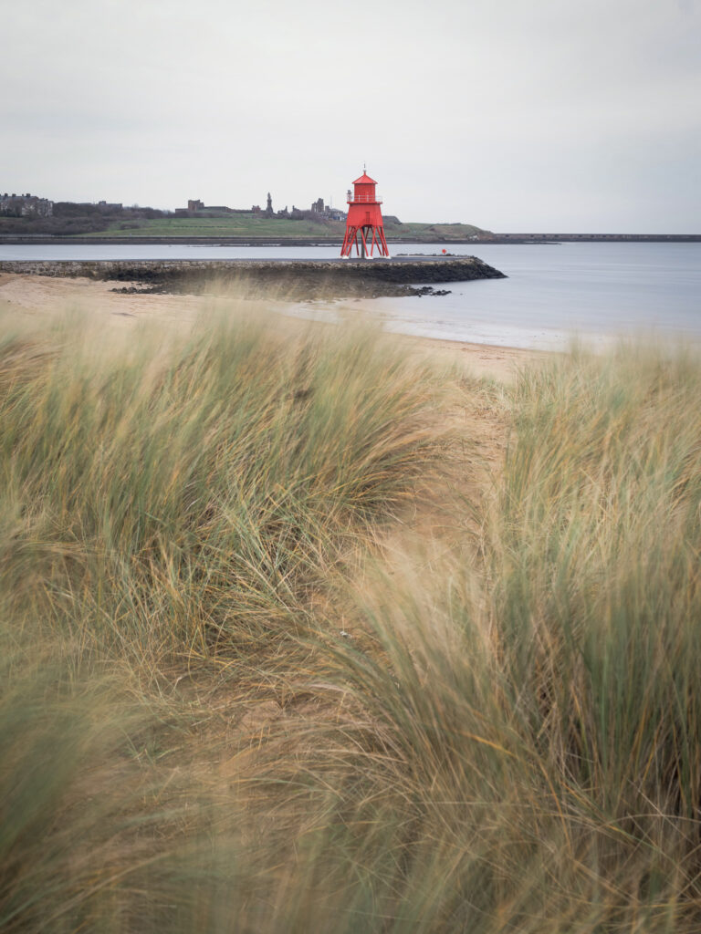 England, Tyne & Wear, South Shields. Little Haven Beach, looking towards the South Groyne Lighthouse.