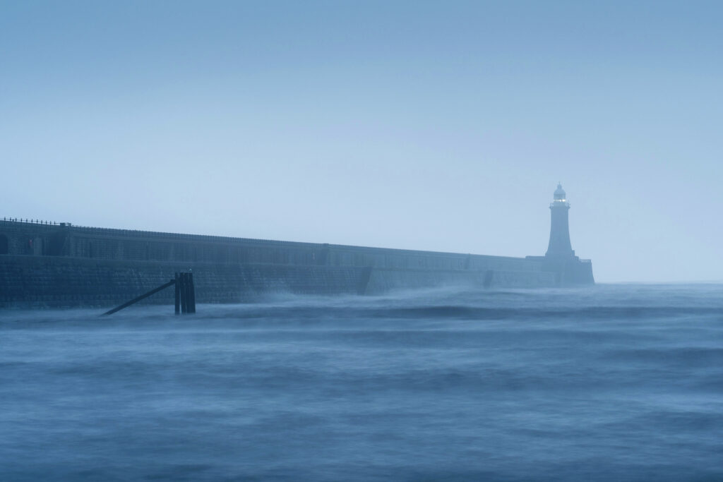 England, Tyne and Wear, Tynemouth. Tynemouth Pier and Lighthouse on a foggy morning at the mouth of the river Tyne.