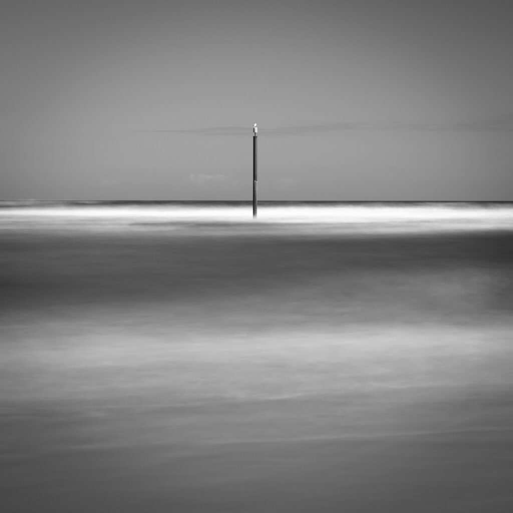 England, Northumberland, Cambois. Marker posts in the north sea