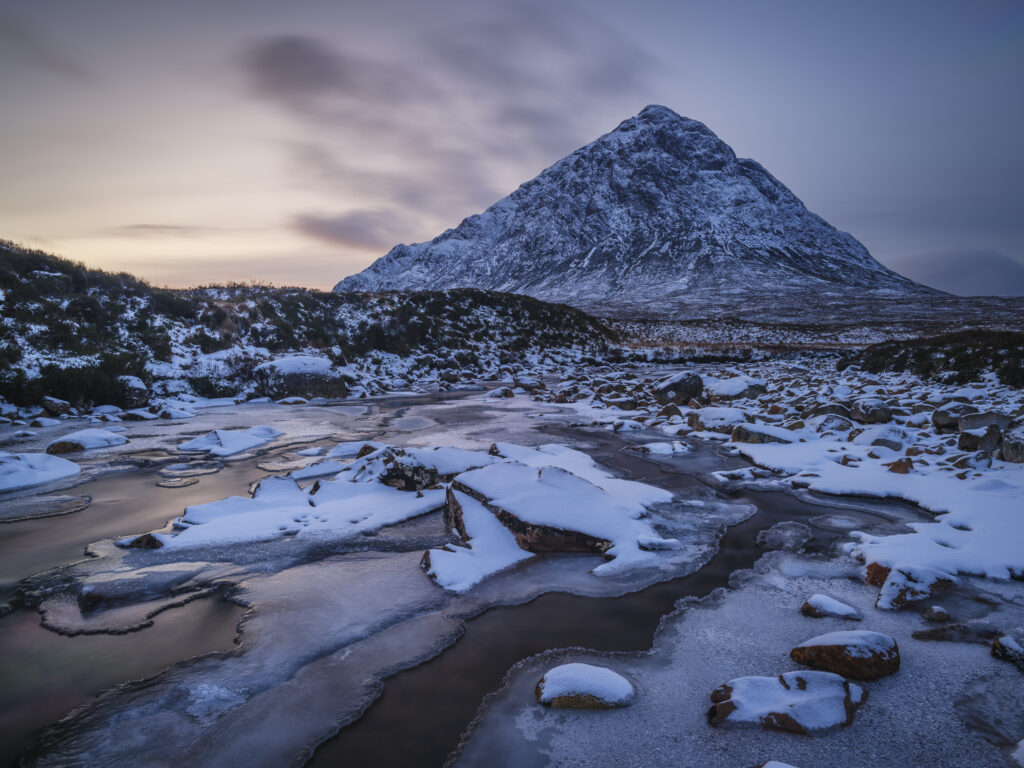 Scotland, Scottish Highlands, Glencoe. The River Etive over looked by the imposing peak of Buachaille Etive Mòr, on a mid winters day at dusk.